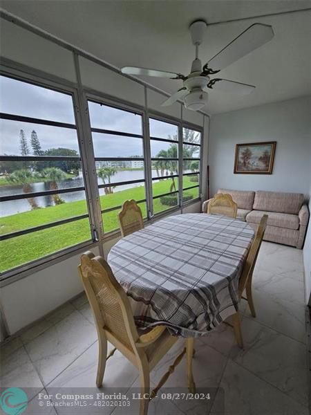 a table and chairs in a room with a large window