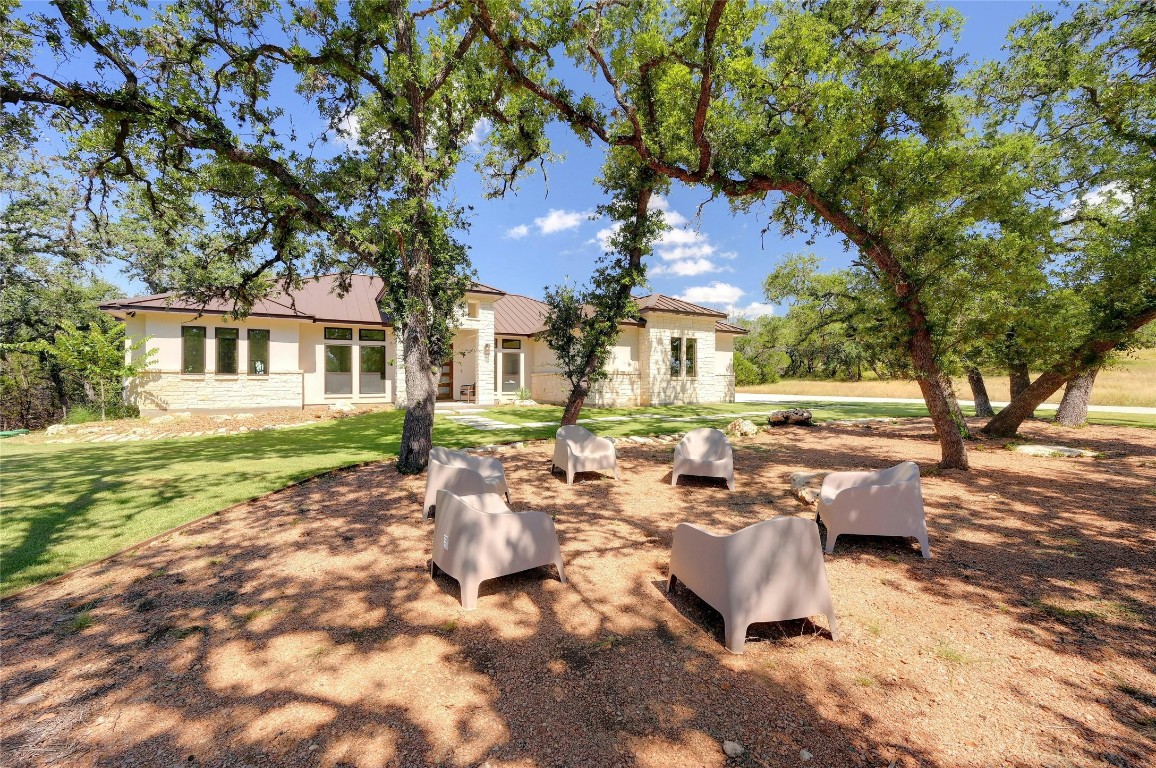 a backyard of a house with yard and outdoor seating