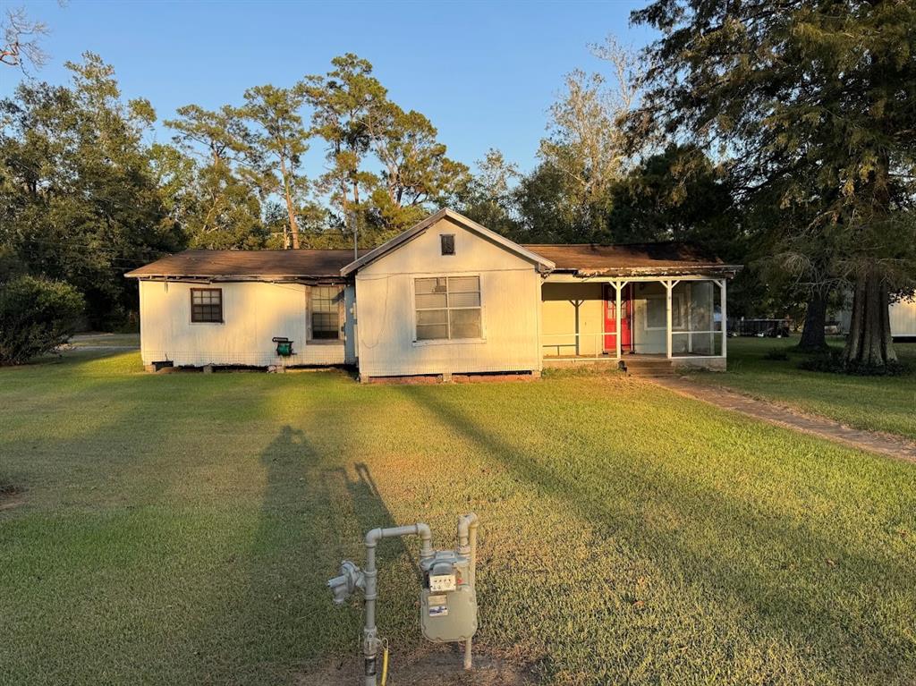 a front view of house with yard and trees around