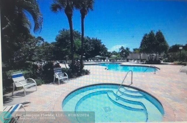 an outdoor space with swimming pool and furniture