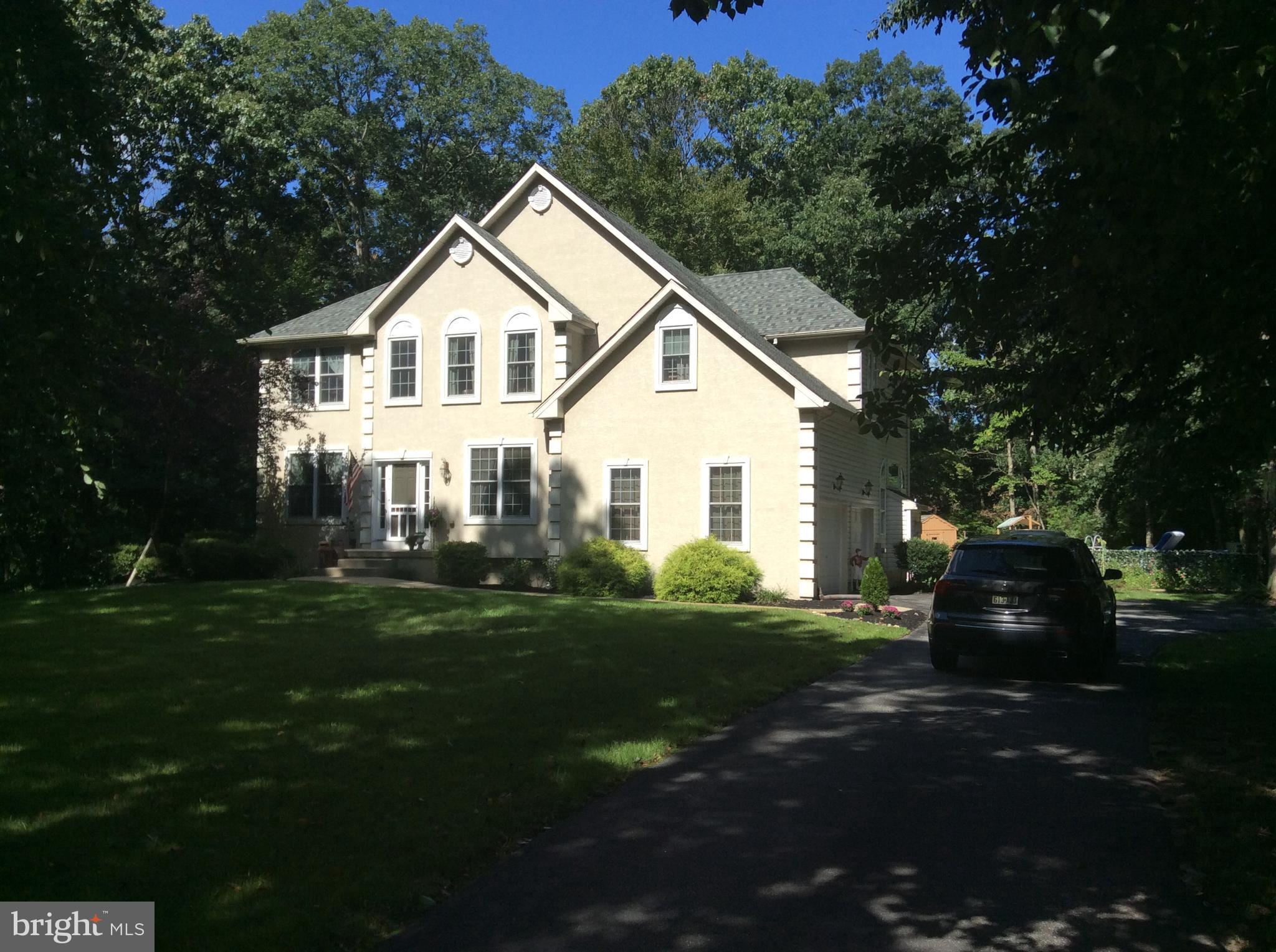 a view of house with outdoor space and garden