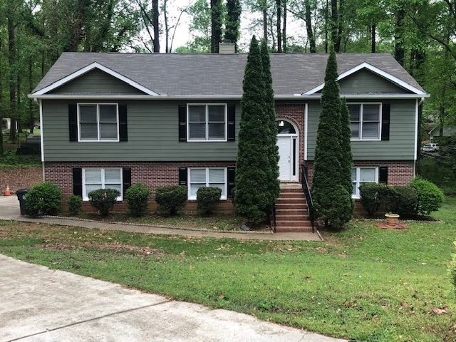 a front view of a house with a yard