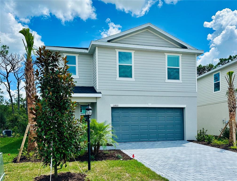 a front view of a house with a yard and garage