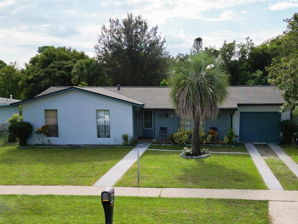 a front view of house with yard and green space