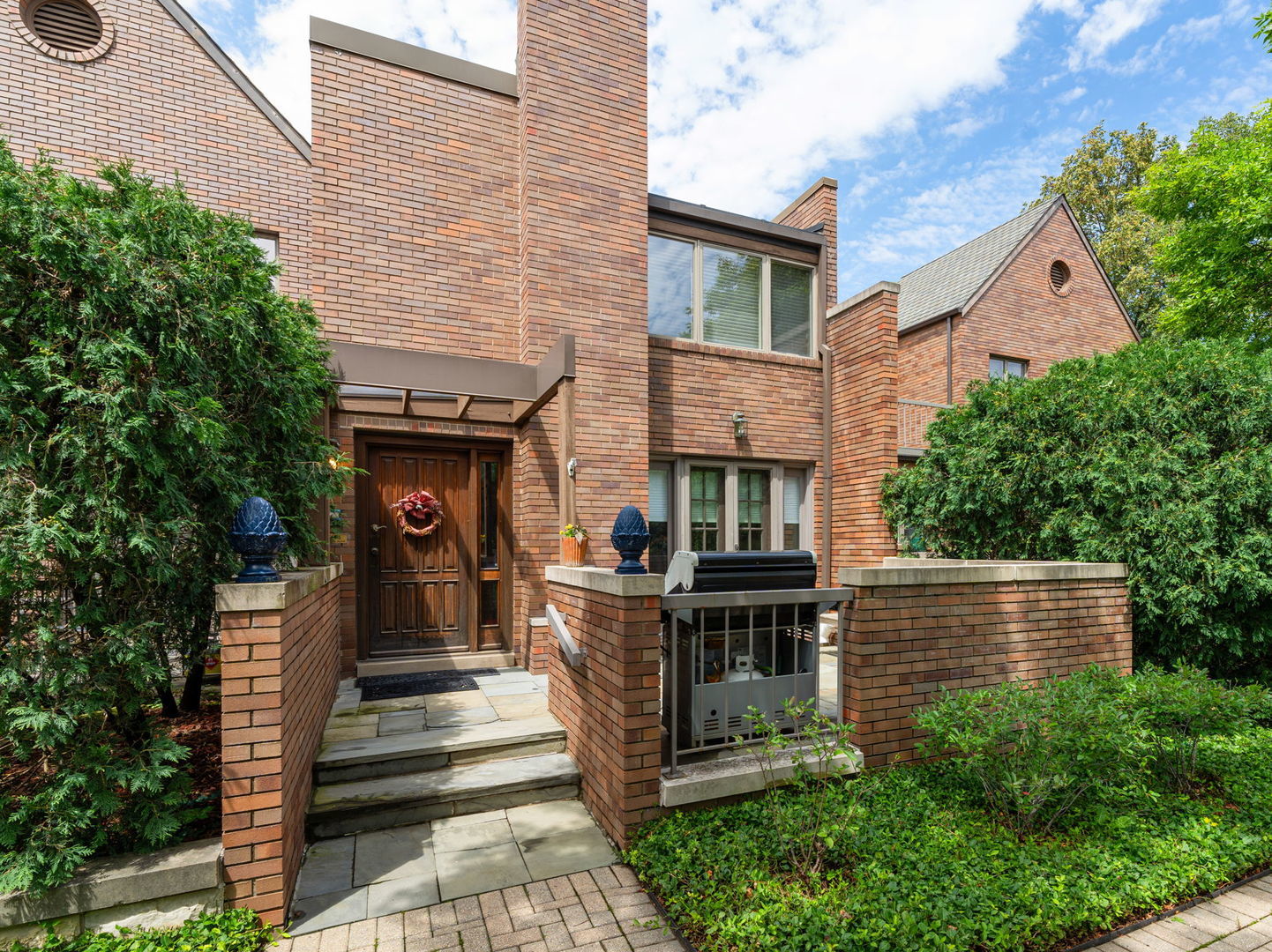 a view of a house with a small yard and plants