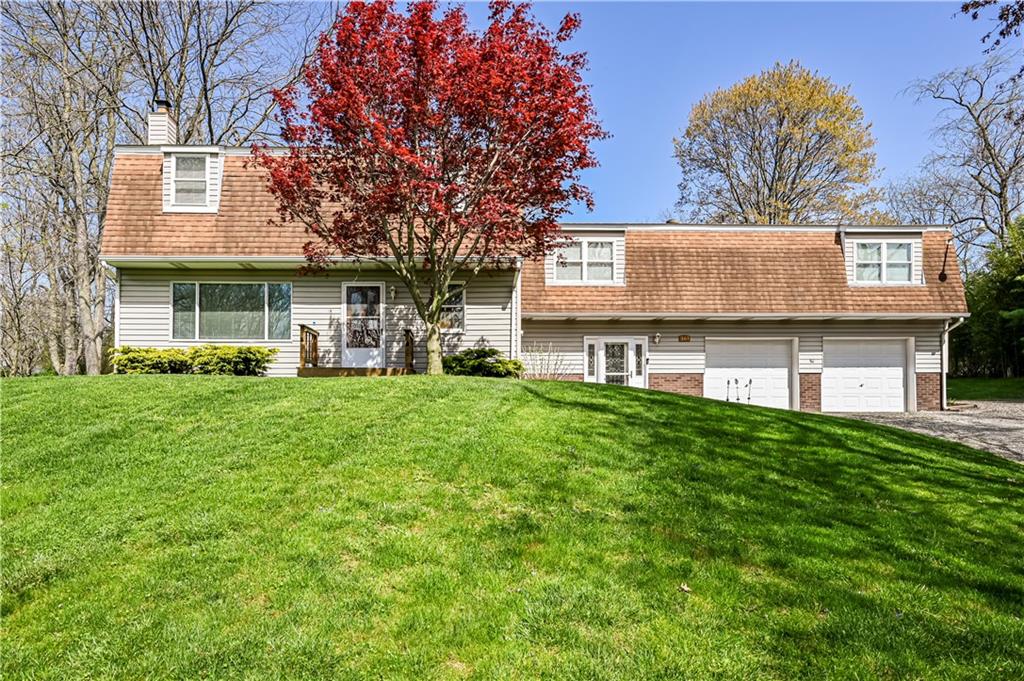 a view of a house with a yard porch and sitting area