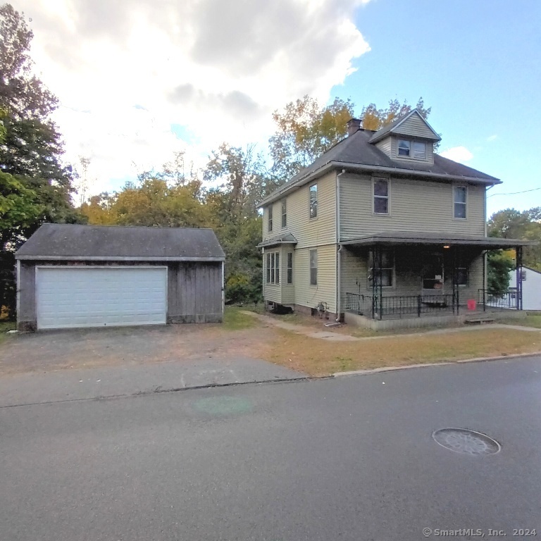 a view of a house with a outdoor space and a car parked