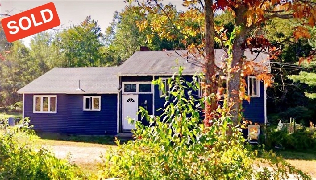 front view of a house with a tree