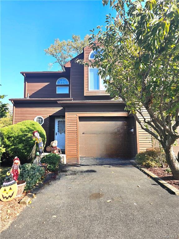 View of front of home with a one car garage.