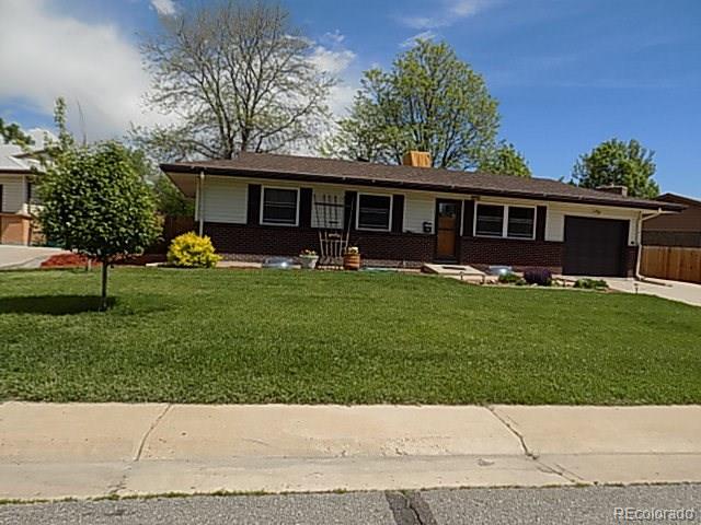 a front view of house with a garden and patio