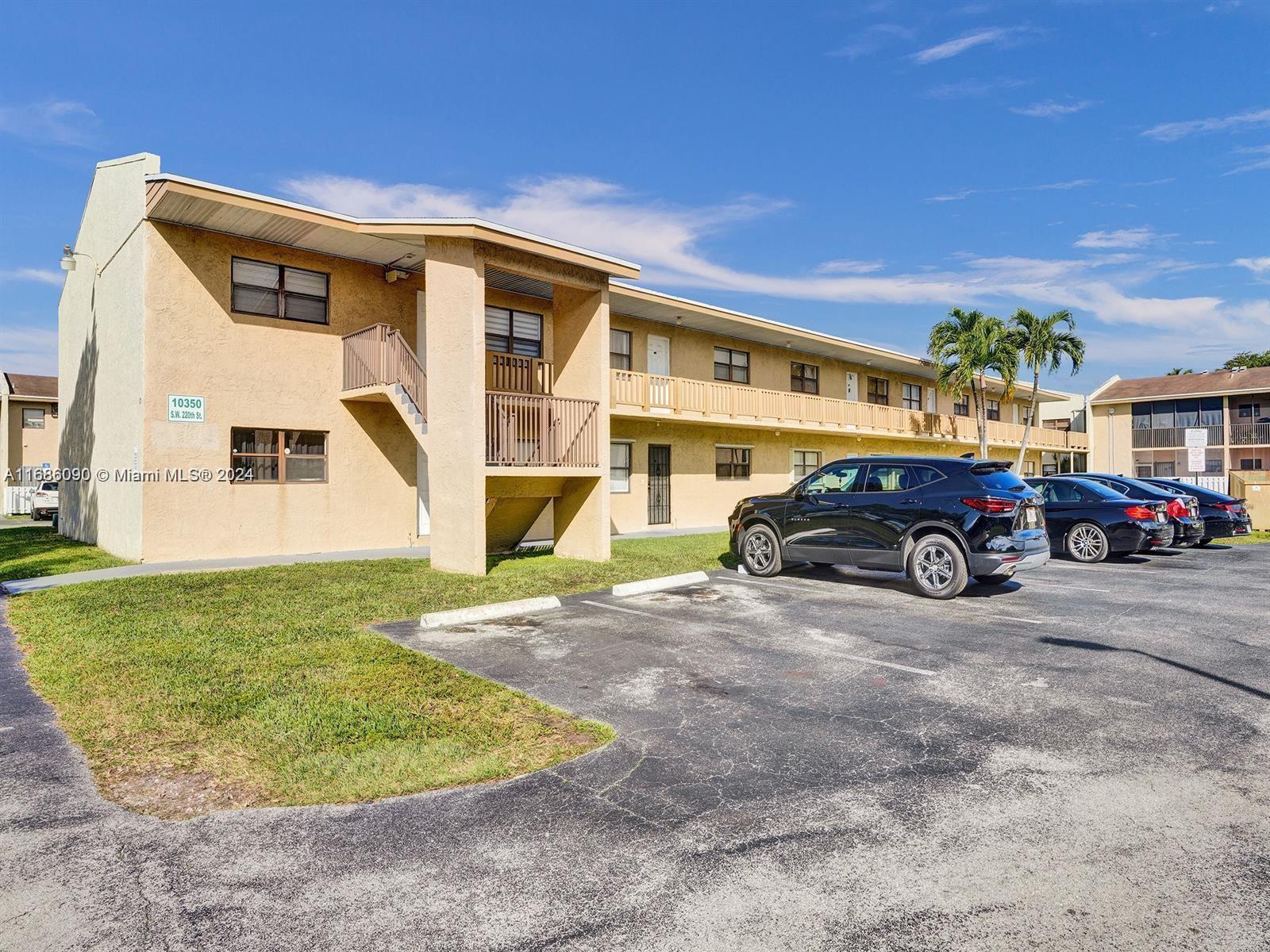 a view of a car park in front of a house