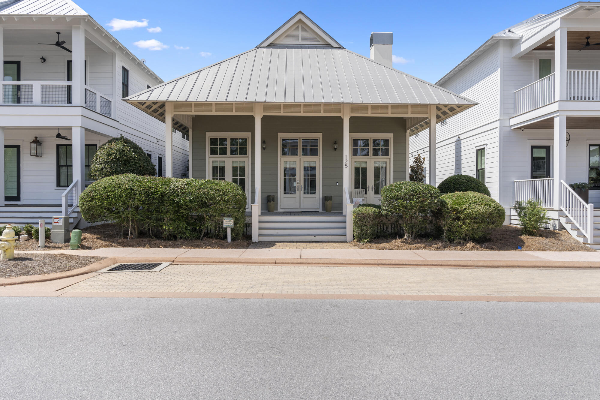 a front view of a house with a garden