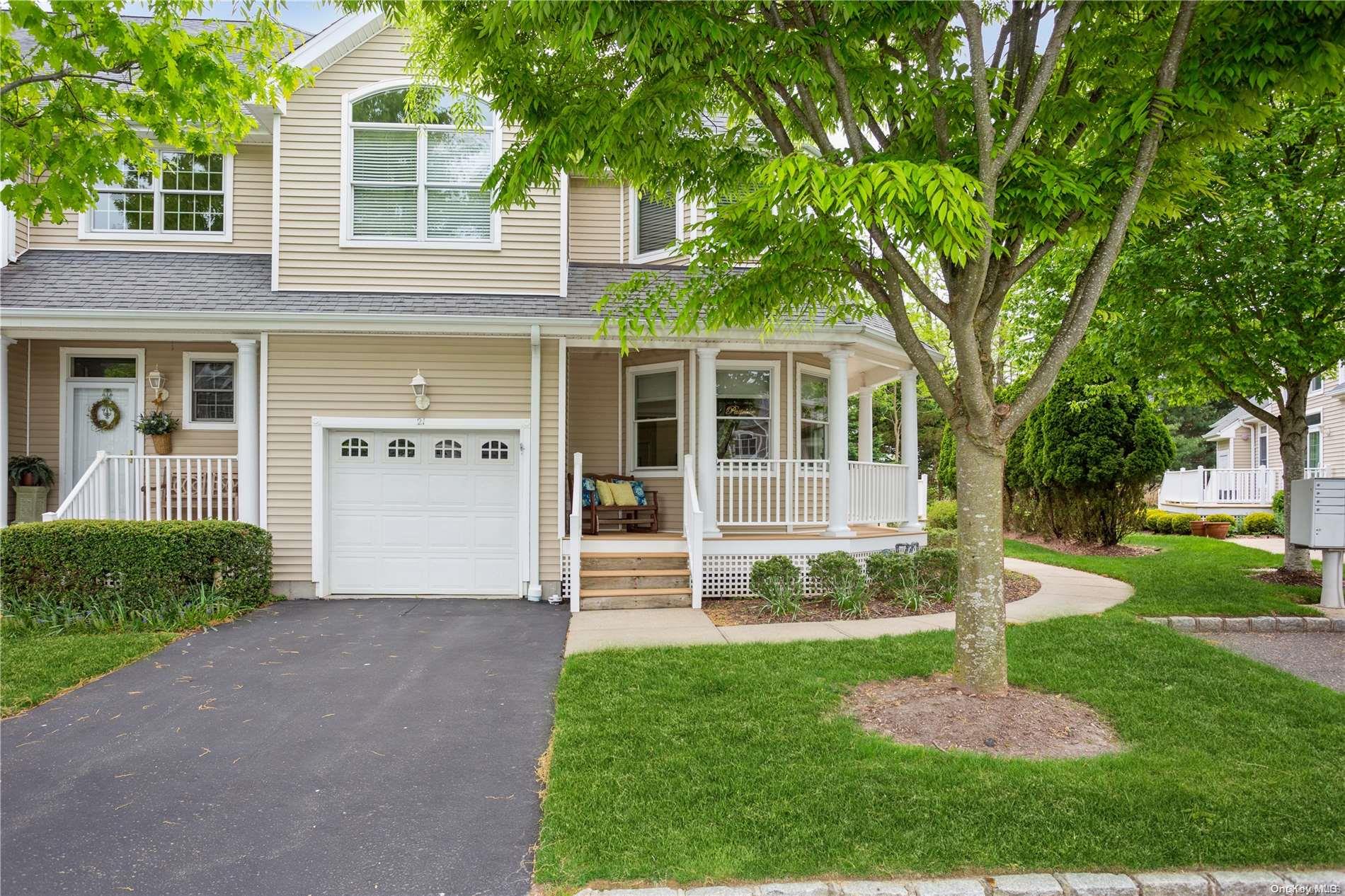 a front view of a house with a yard and fountain