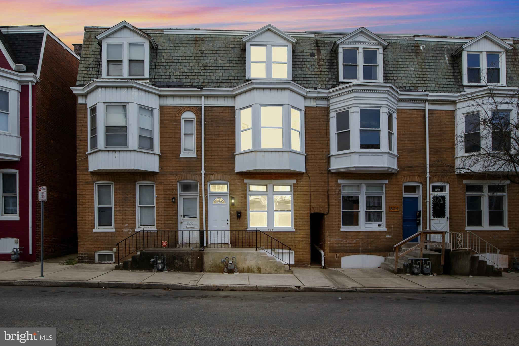 a front view of a residential apartment building with a yard