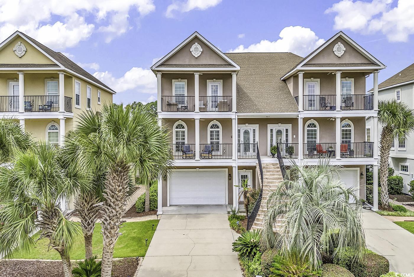 Coastal home with a garage and a balcony