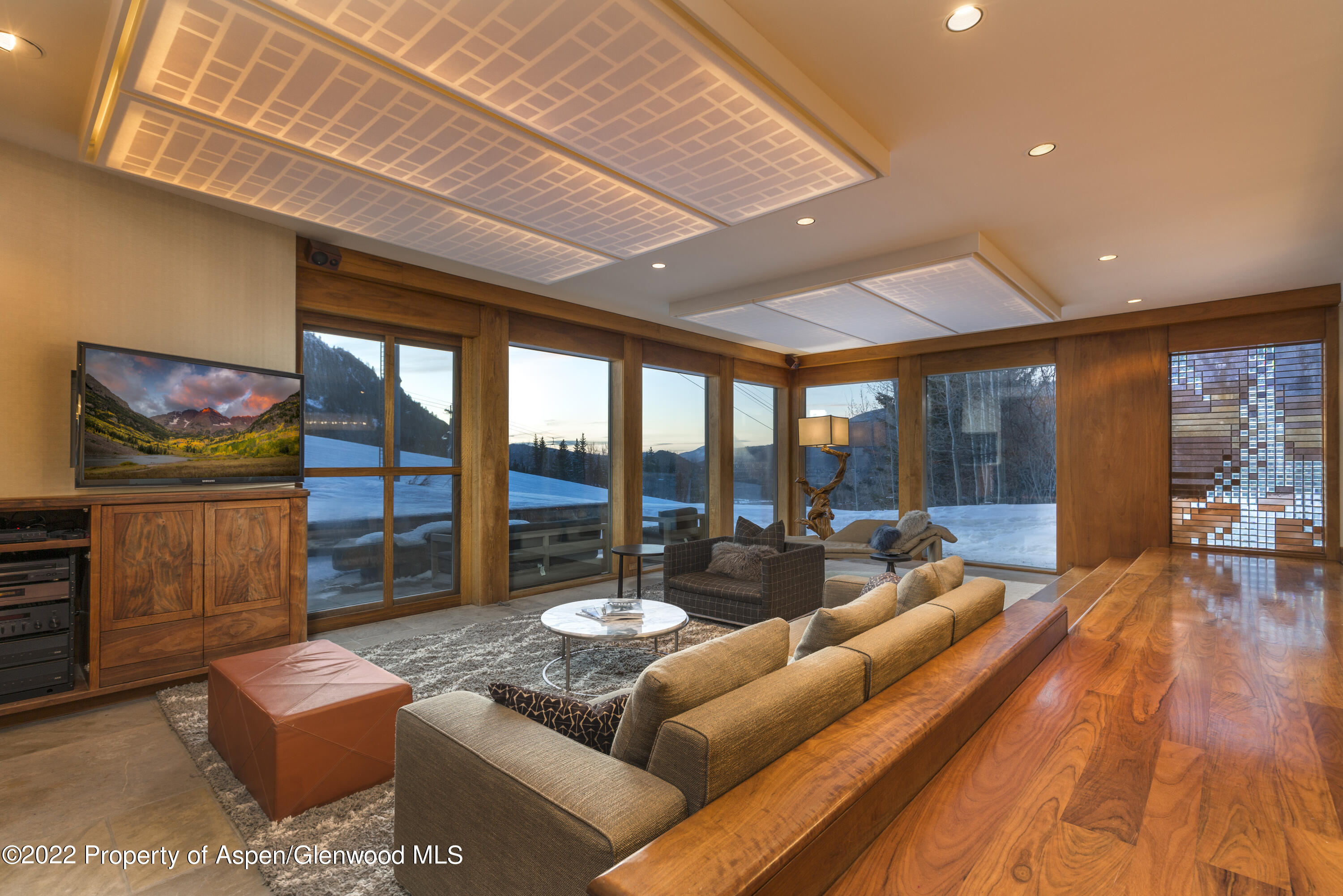 a living room with furniture and a floor to ceiling window