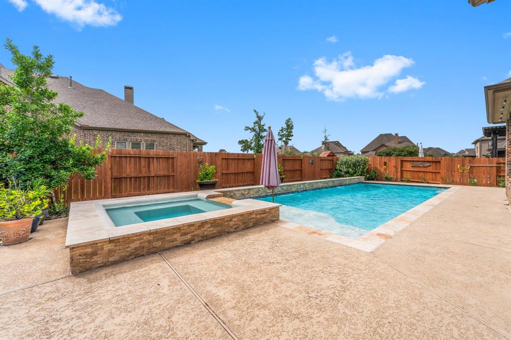 This home is located in the gated section of Harmony. Stunning Highland Homes floorplan! Lush landscaping & beautiful curb appeal with sparkling pool and covered back patio!