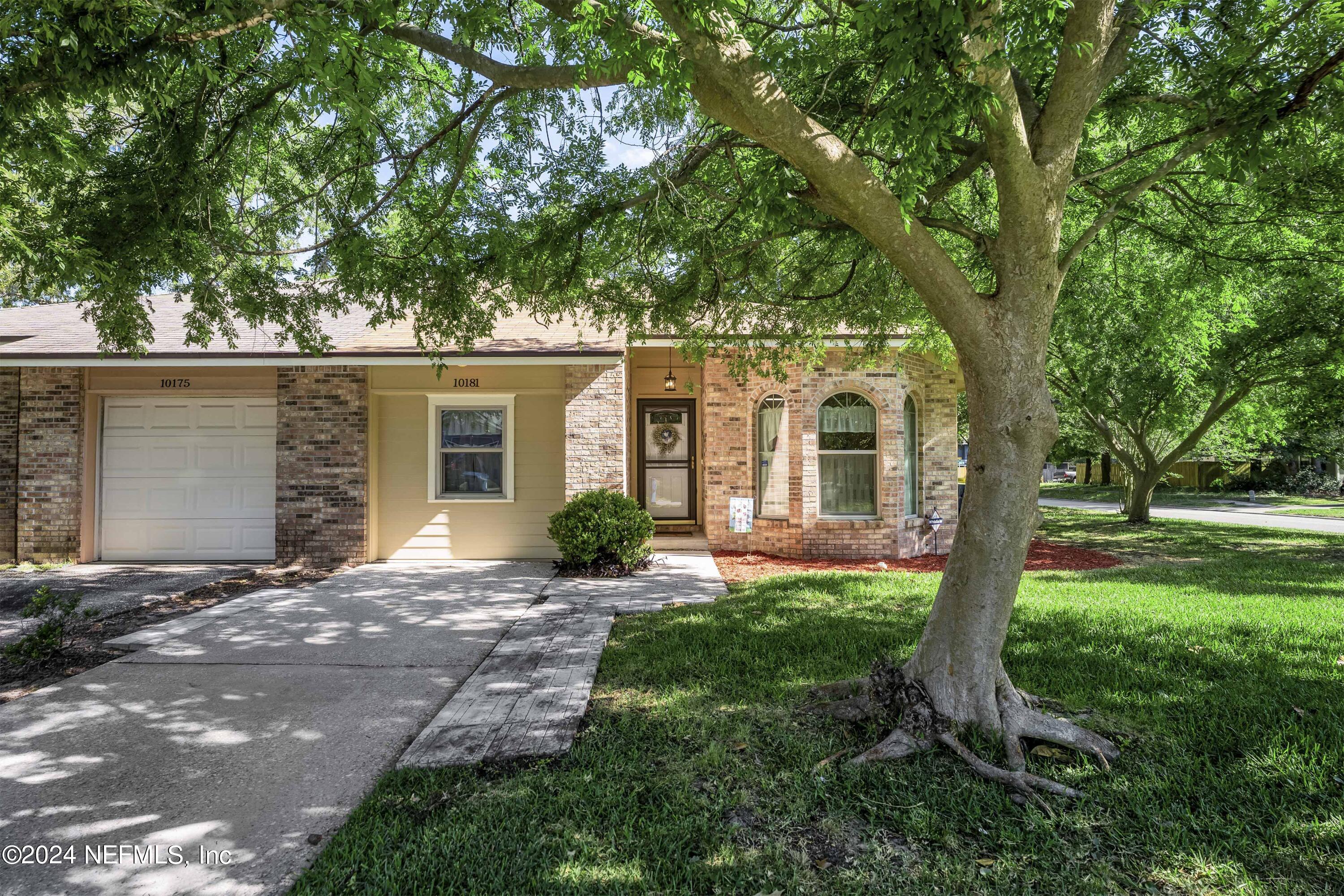 a front view of a house with yard