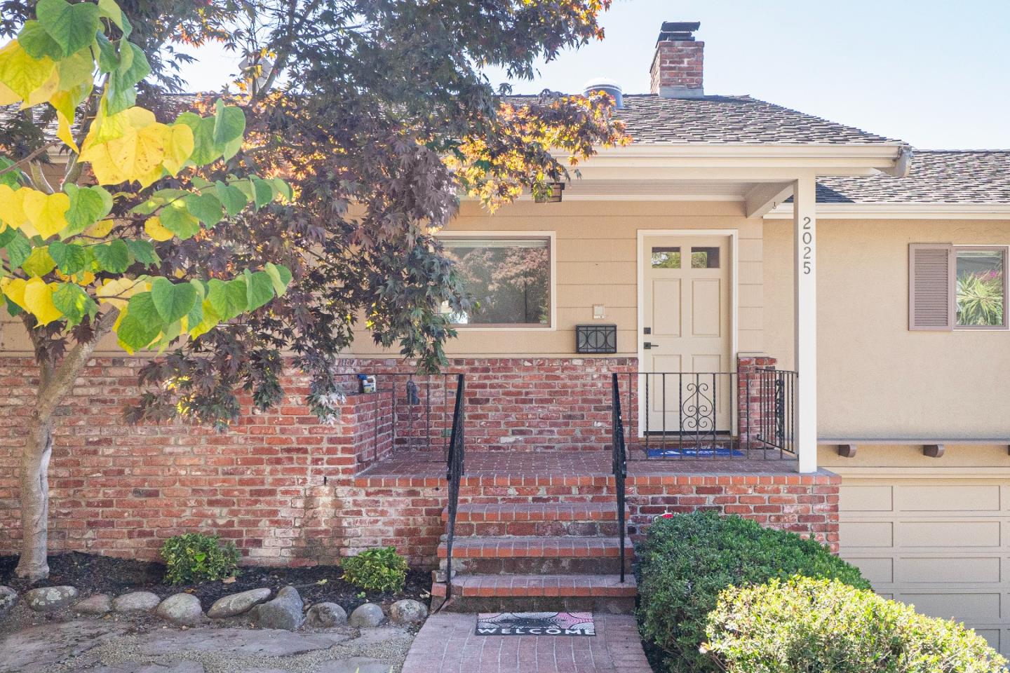 a front view of a house with a garden