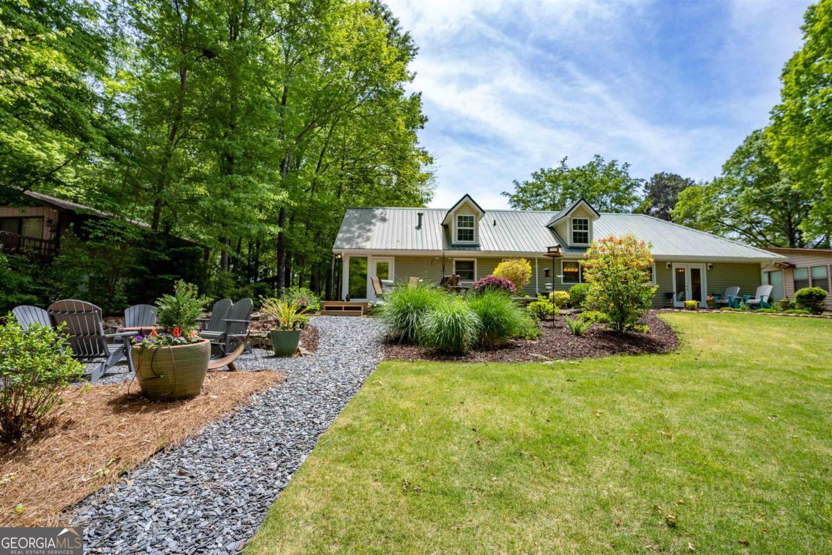 a view of a house with backyard and sitting area