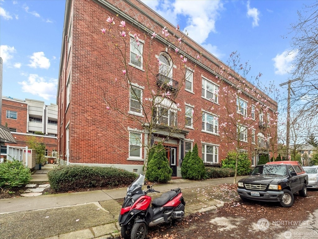 a car parked in front of brick building