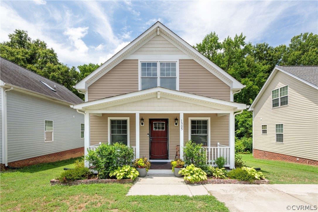 a front view of a house with garden and porch