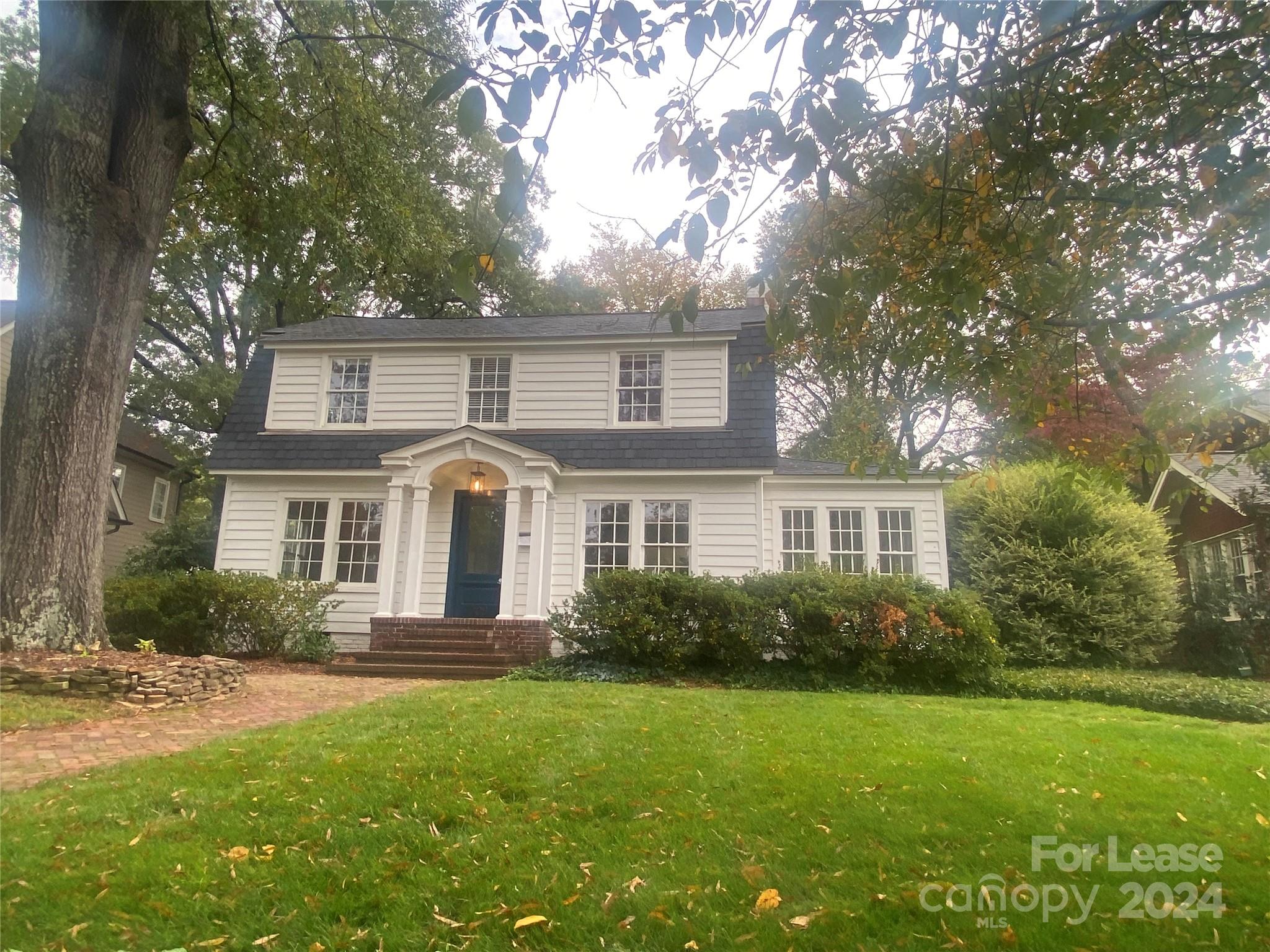 a front view of house with yard and green space