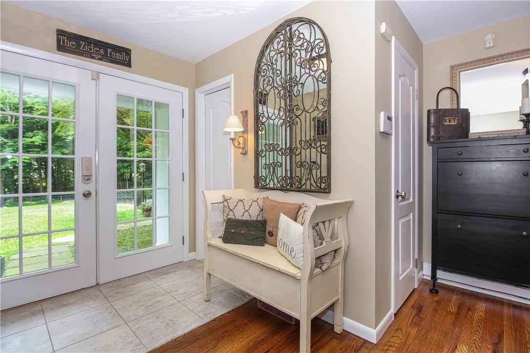 a view of front door with furniture and a window