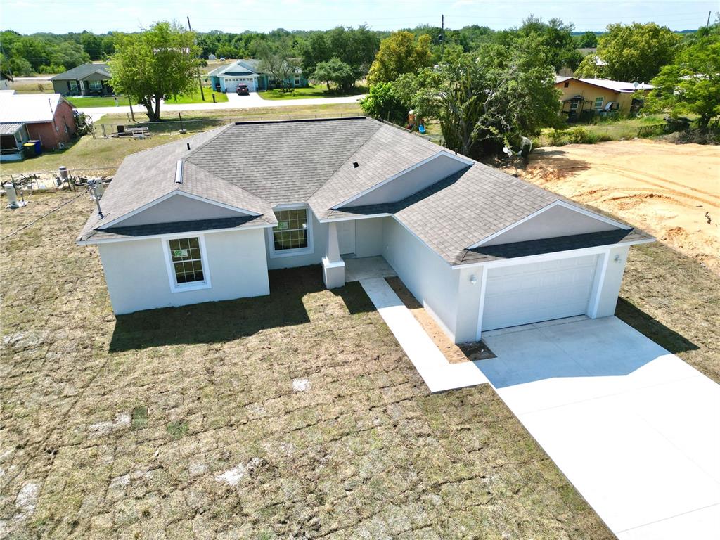 a aerial view of a house with a yard