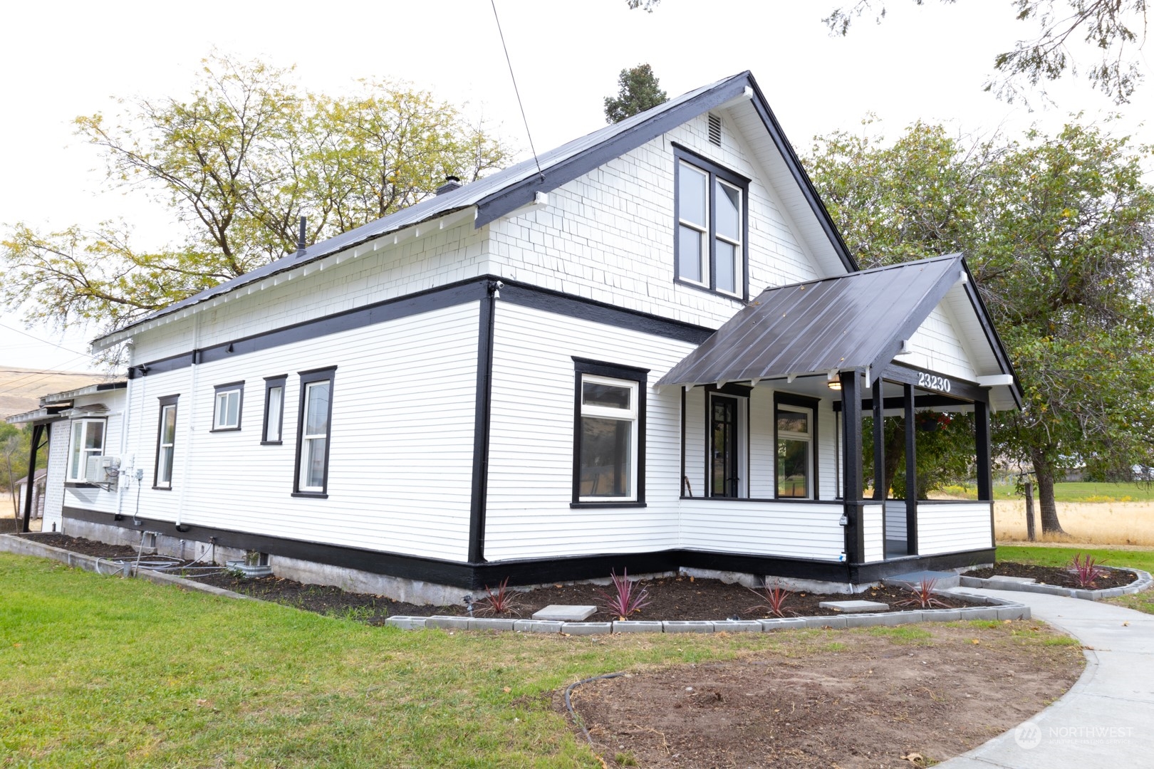 a front view of a house with a garden