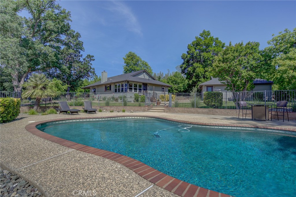 a view of swimming pool with outdoor seating and green space