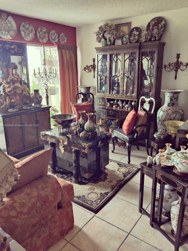 a living room with furniture a window and a chandelier