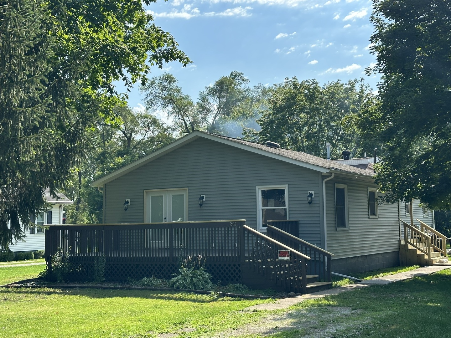 a view of house with backyard and swimming pool