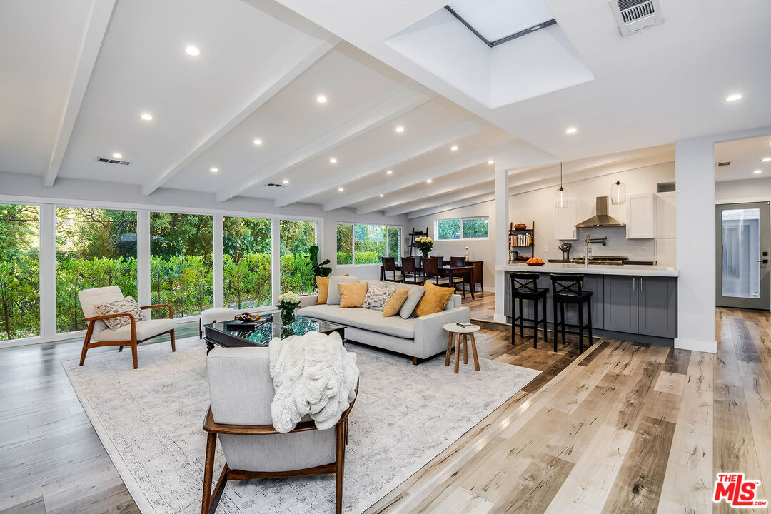 a living room with lots of furniture and a large window