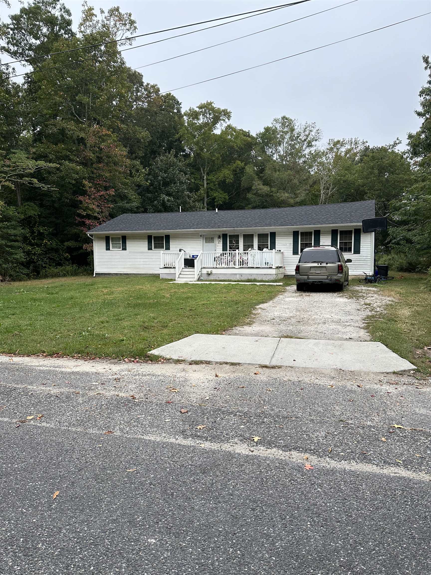 a front view of a house with a garden and parking space