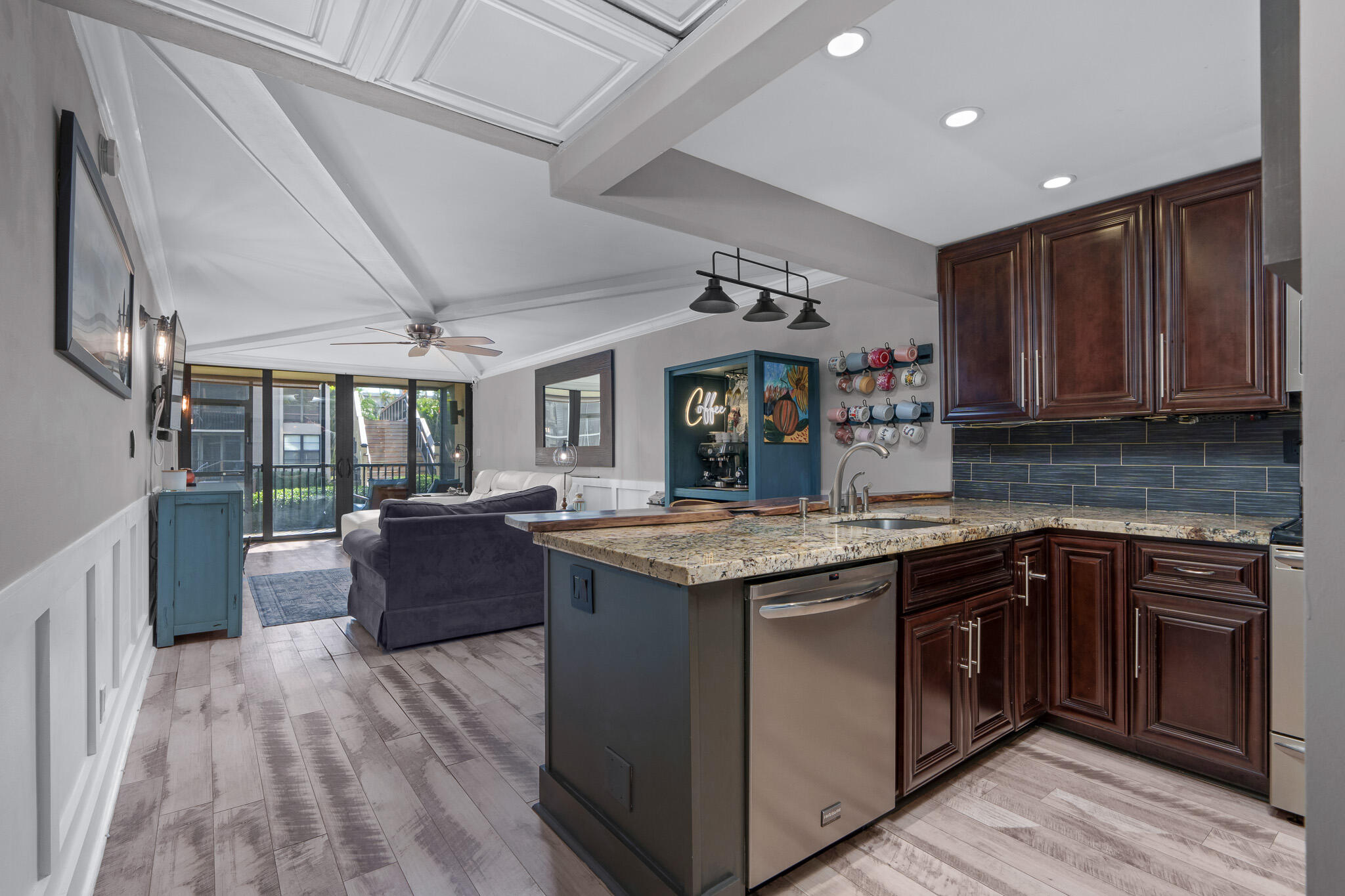 a kitchen with stainless steel appliances granite countertop a stove and a wooden floors