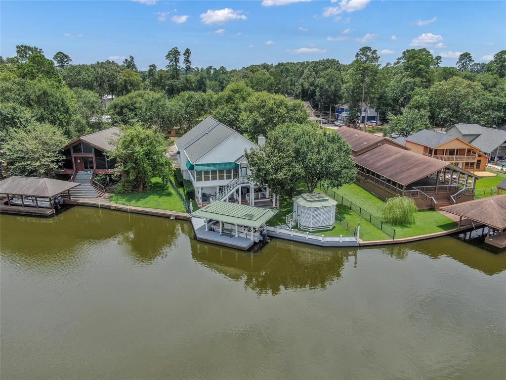 an aerial view of a house with a garden and lake view