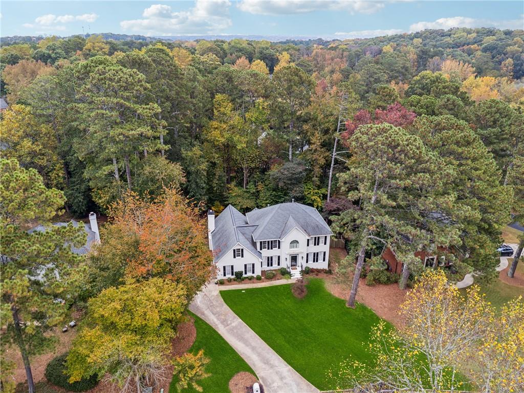 an aerial view of a house with a yard