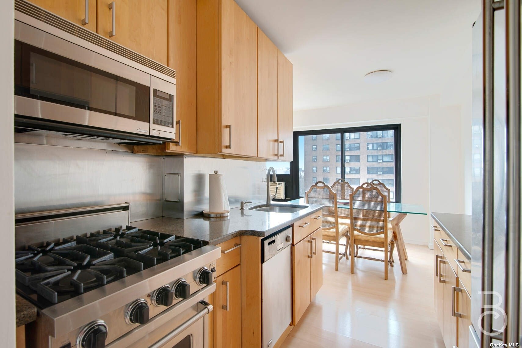 a kitchen with a stove a microwave and wooden floor