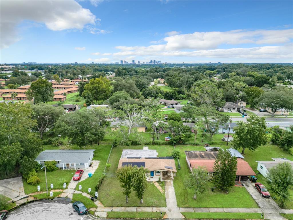 an aerial view of residential houses with outdoor space and street view