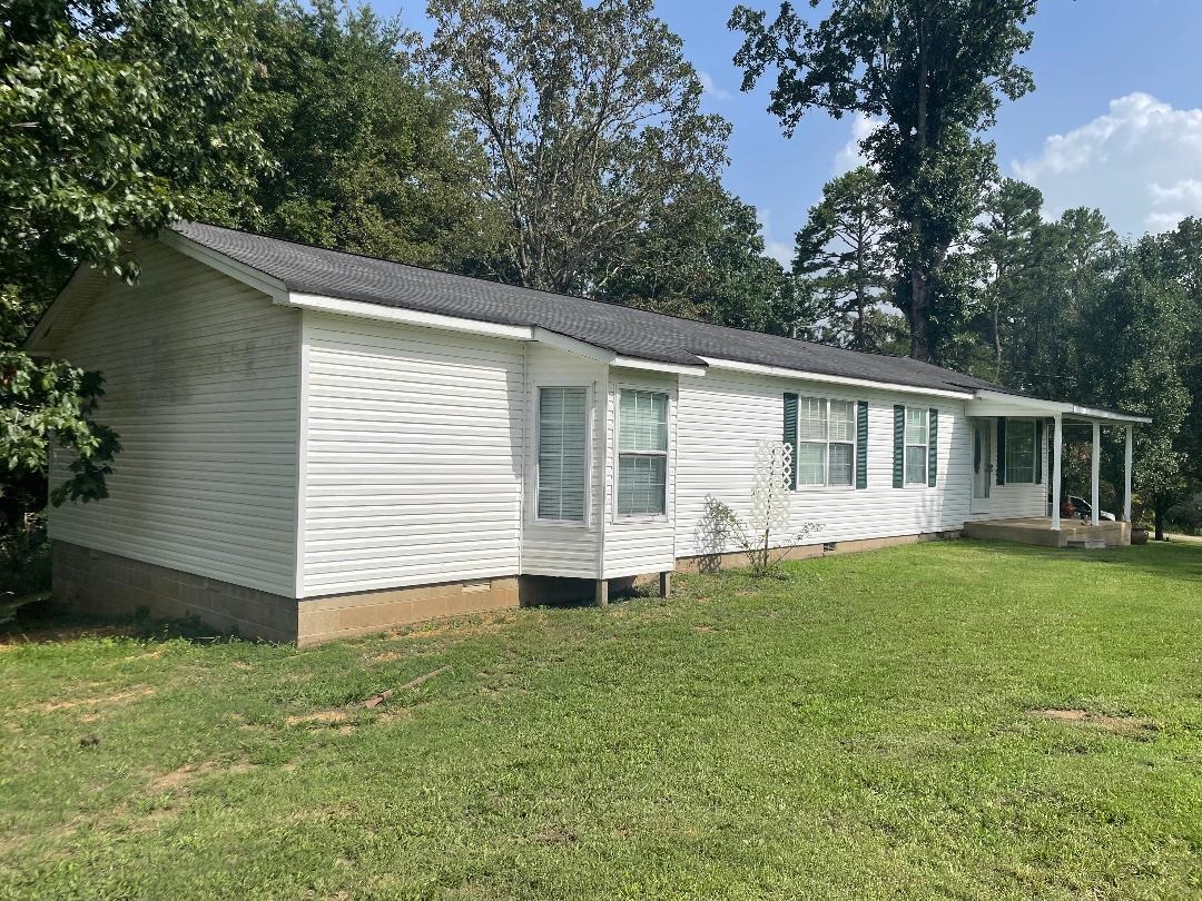 a view of a house with a backyard