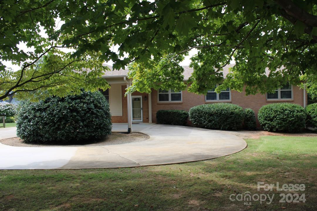 a view of a house with a yard and garage