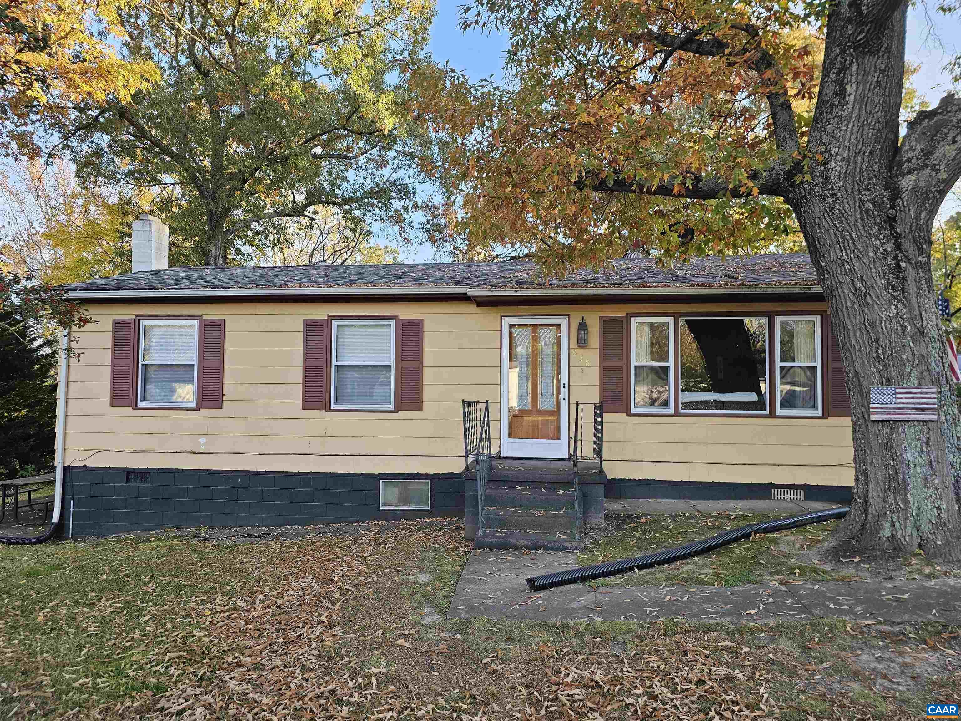 a view of house with a backyard