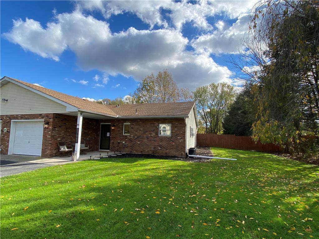 a view of a house with a yard and pathway