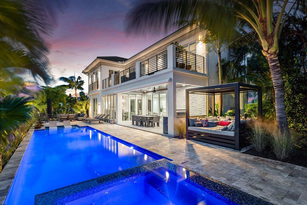 a view of a house with swimming pool and sitting area