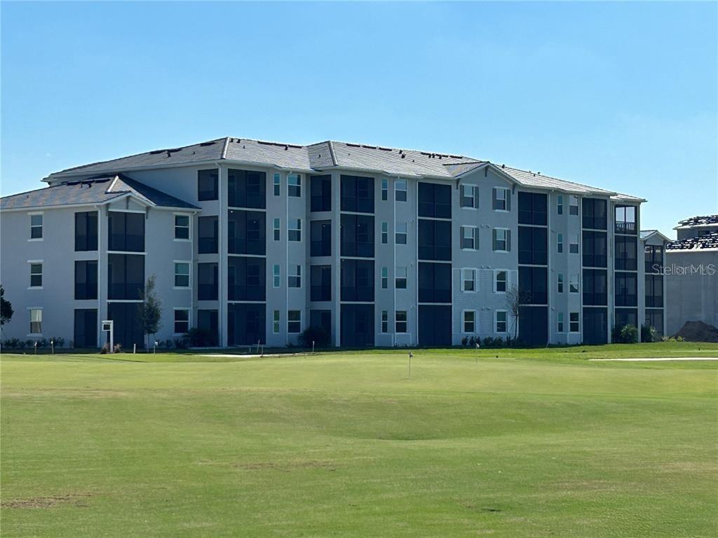 a view of a building with a backyard