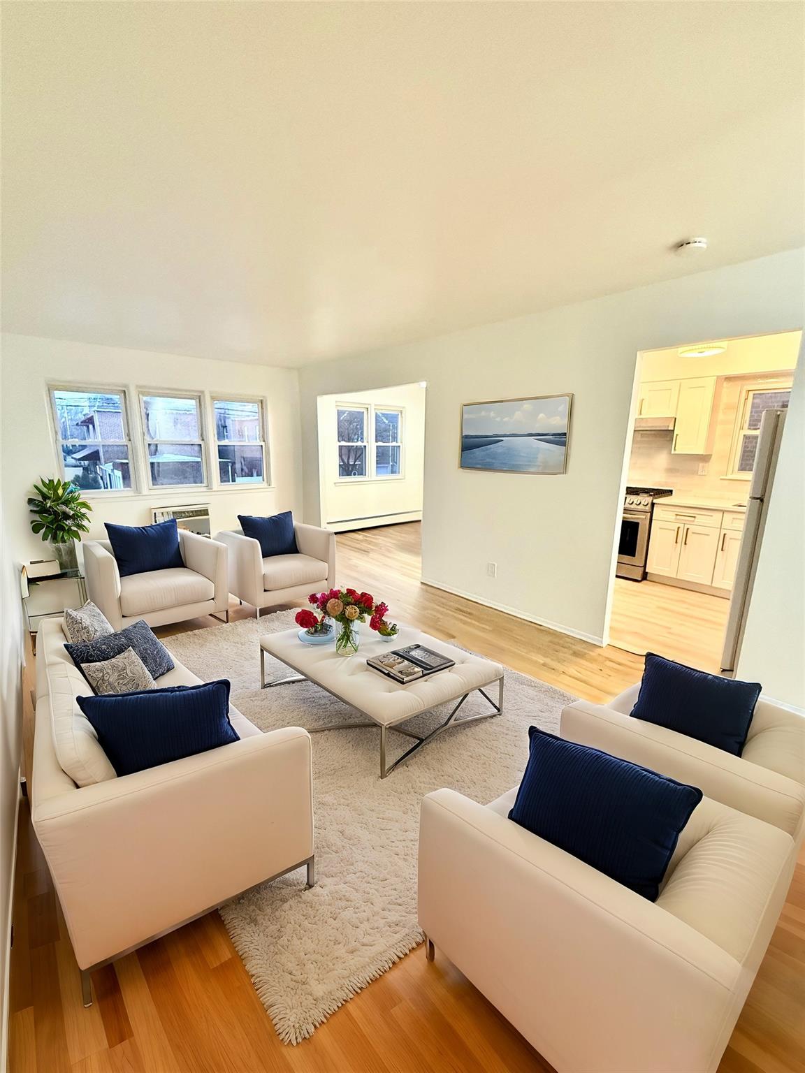 Living room featuring light wood-type flooring and baseboard heating