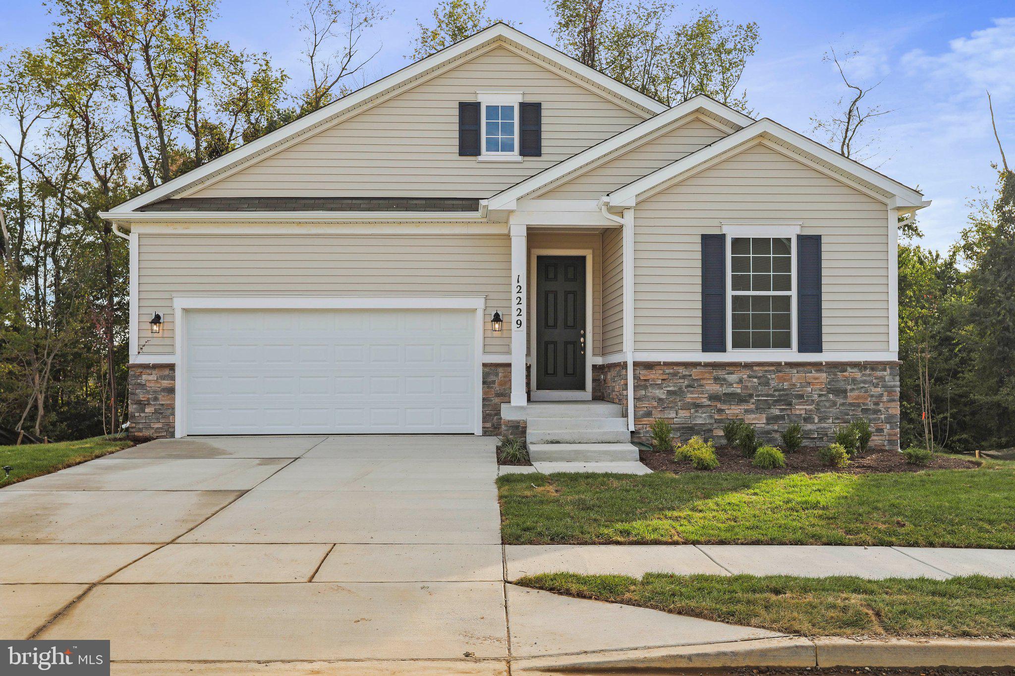 a front view of a house with garage