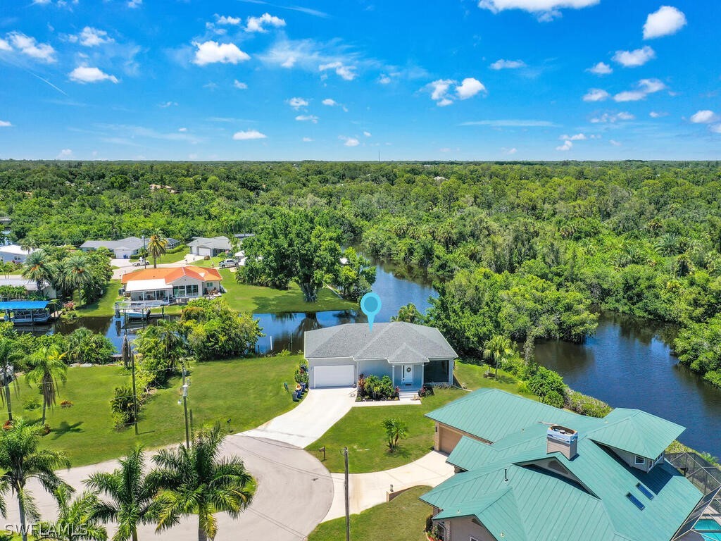 an aerial view of a house with swimming pool and garden