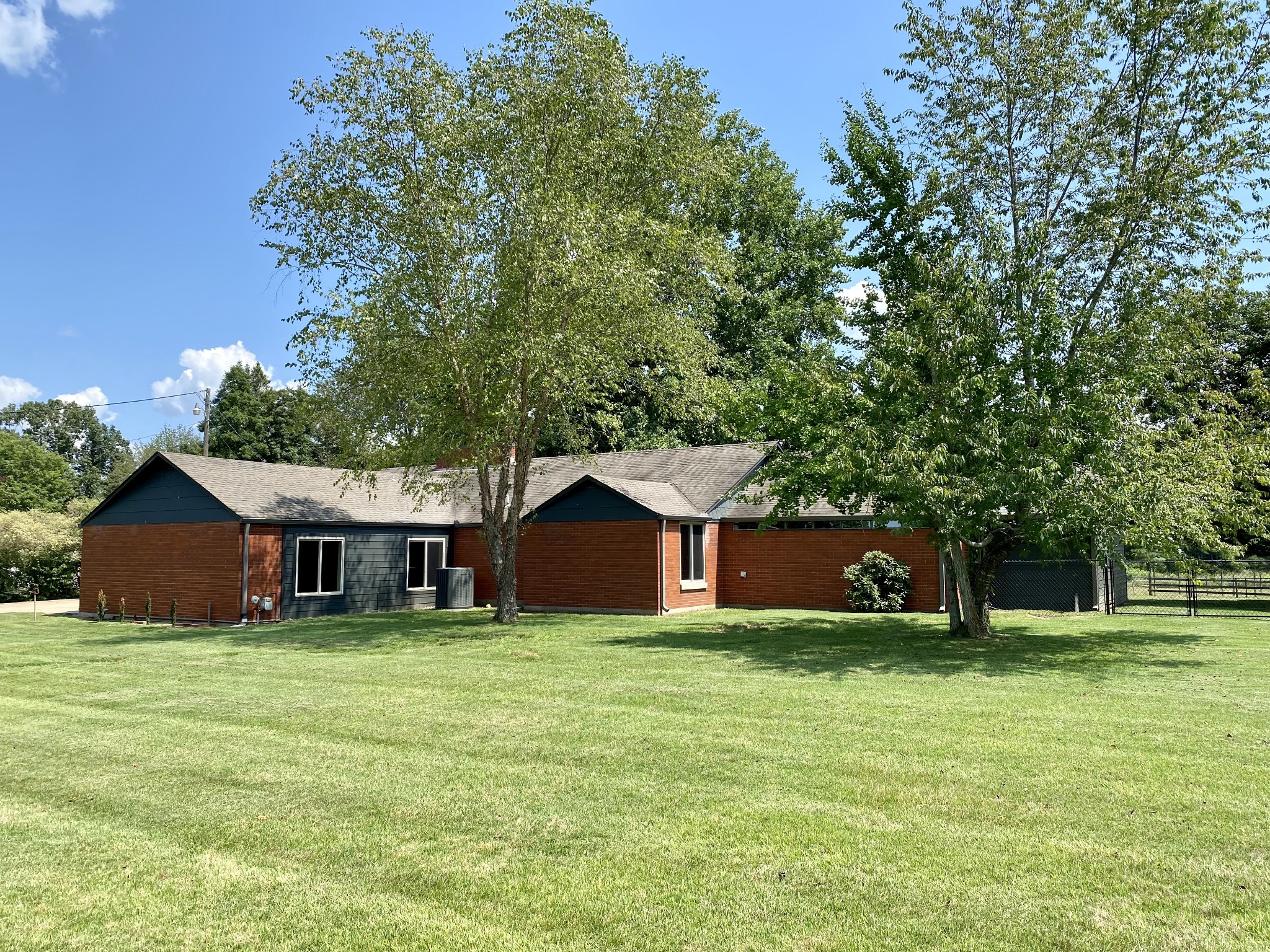 a view of a house with a yard and tree